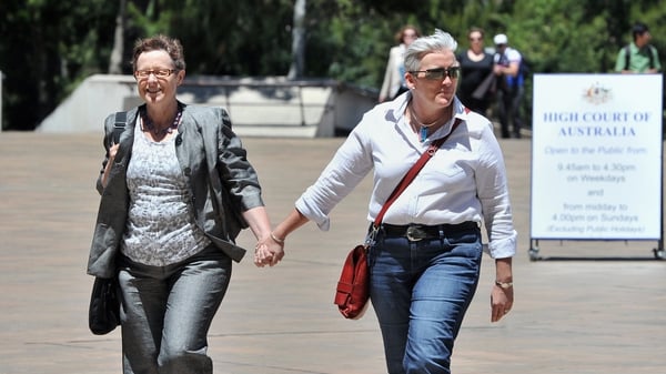 A same-sex couple arrives at the High Court of Australia in Canberra