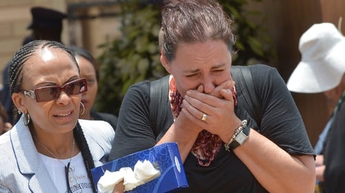 A woman cries after paying her respects to Nelson Mandela