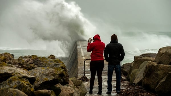 Big waves crash against a break-water pier during a storm in Esquibien, in the western region of Brittany, France