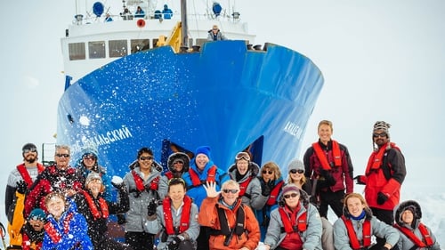 Passengers pictured in front of the Akademik Shokalskiy ship