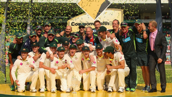 The Australian team and support staff celebrate with the Ashes urn