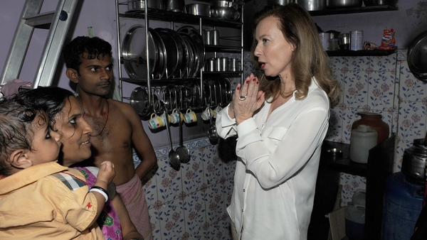 Valerie Trierweiler, the ex-partner of French President Francois Hollande, interacts with residents during a visit to the Ekta Nagar slums in the Mandala area of Mumbai