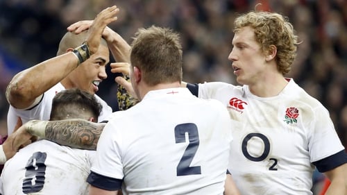 England's centre Luther Burrell (L) is congratulated by teammates after scoring a try