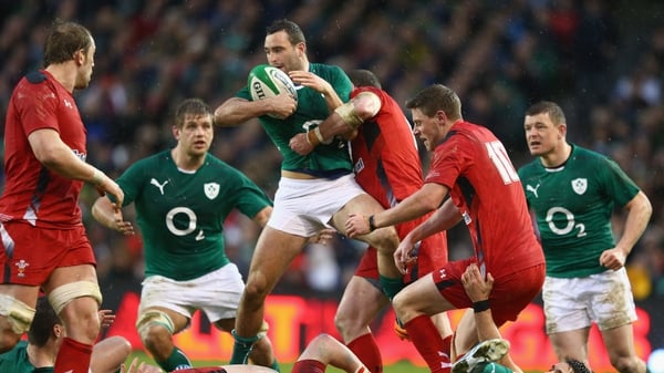 Ireland's Dave Kearney attempts to offload while under pressure from an Alex Cuthbert tackle