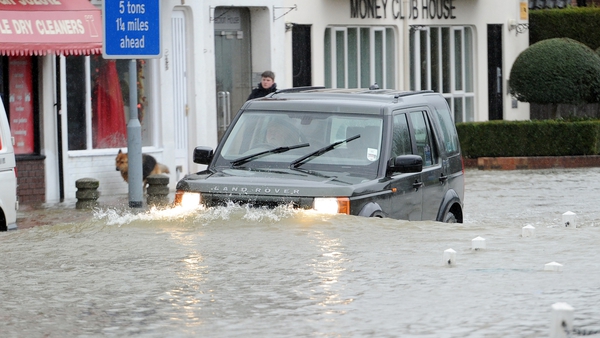 A car drives through flood waters in the village of Datchet in Berkshire (Pic: EPA)