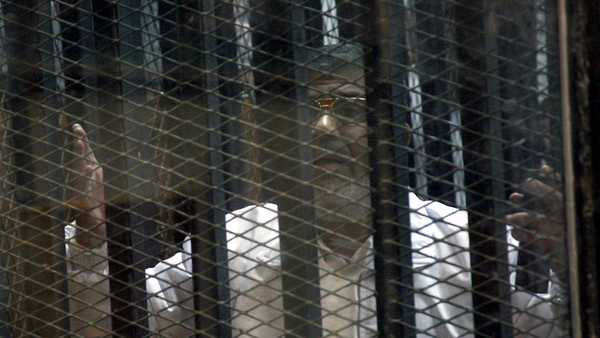 Mr Mursi's legal team protested they could not hear their client speak from inside a soundproof glass cage