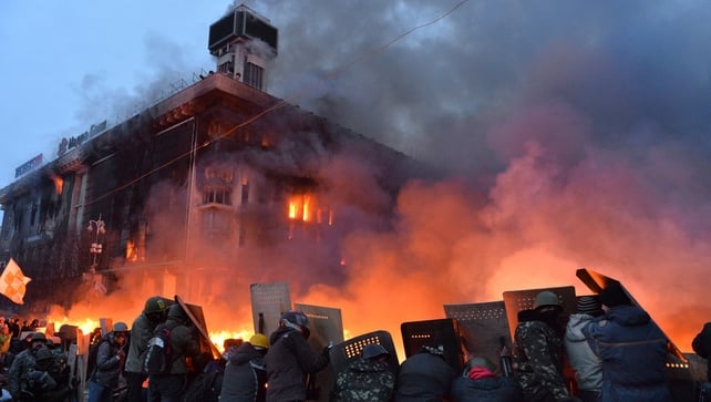 Anti-government protesters protected themselves behind shields as they clashed with police