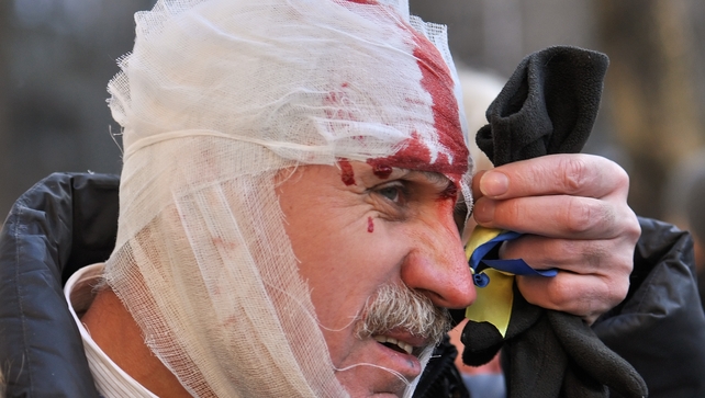 The violence flared after thousands of protesters rallied outside parliament to press politicians to strip Mr Yanukovych of his powers