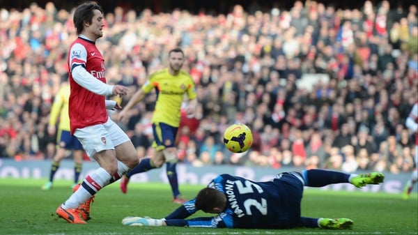 Tomas Rosicky lifts the ball over lifts the ball over Vito Mannone for Arsenal's third goal