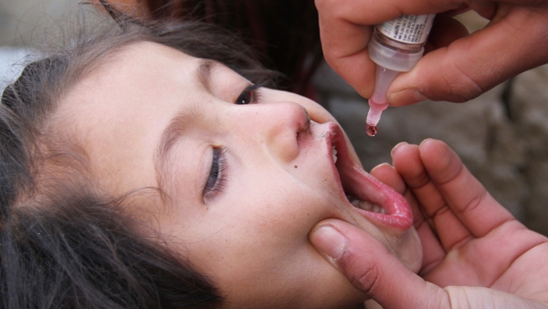A child gets the polio vaccine in Afghanistan after a young girl was diagnosed with the disease in Kabul earlier this month