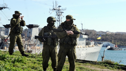 Russian forces patrol near the Ukrainian navy ship Slavutich in Sevastopol harbour