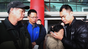 A relative of a passenger onboard Malaysia Airlines flight MH370 cries as she waits for news at Beijing International Airport