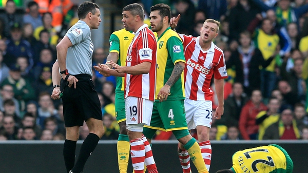 Jonathan Walters is about to receive his marching orders from referee Andre Marriner
