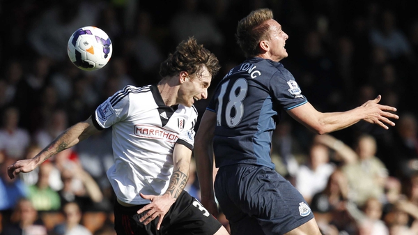 Fulham's Fernando Amorebieta and Luuk de Jong of Newcastle contest a high ball
