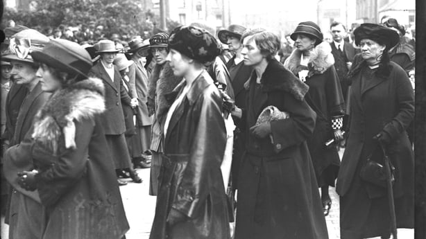 Cathal Brugha's funeral, 1922. Cumann na mBan women hold hands for crowd control. Caitlin Brugha and Muriel MacSwiney are pictured in the centre. Mary MacSwiney is on the far right. © RTÉ Photographic Archive