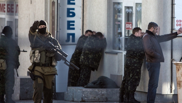 Armed Russian forces arrest Ukrainian army officers during an operation in Simferopol