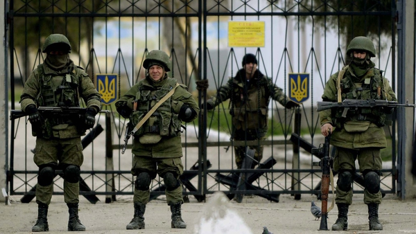 Armed men in military uniform outside a Ukrainian military unit in the village of Perevalnoye, outside Simferopol