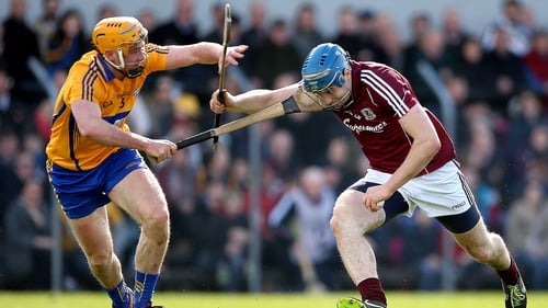 Cian Dillon and Conor Cooney battle for possession in Ennis