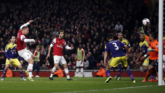 Lukas Podolski guides home Arsenal's opening goal