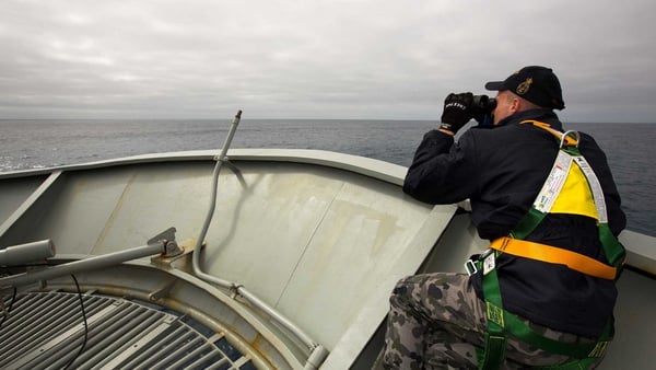 Able Seaman Kurt Jackson keeps watch on the forecastle of the Royal Australian Navy ship HMAS Success during the search for the plane (Pic: EPA)