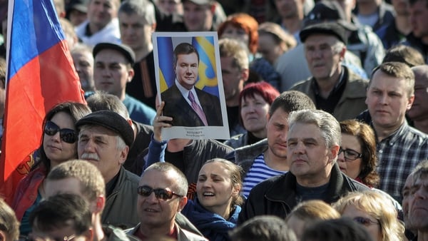 A pro-Russian protester holds a portrait of former Ukrainian president Viktor Yanukovych during a rally in downtown Donetsk, Ukraine earlier this week (Pic: EPA)