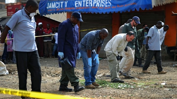 Forensic experts search for evidence at the scene of the explosion