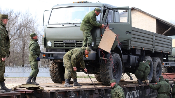 Russian troops unload military trucks in Simferopol in Crimea