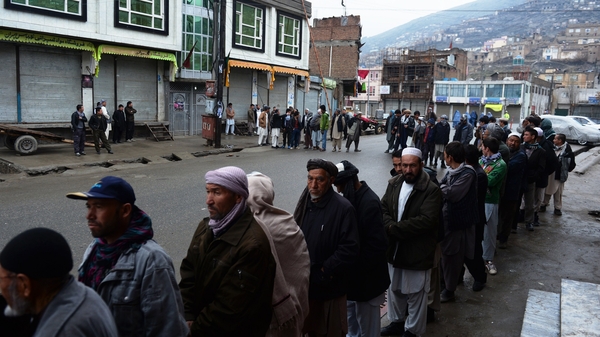 Afghan voters line up outside a local polling station in Kabul