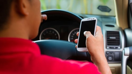 Drivers will be penalised for texting or accessing information on their phones