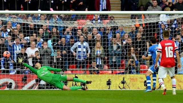 Wigan's Jordi Gomez scores from the penalty spot 
