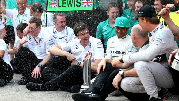 Lewis Hamilton and Nico Rosberg celebrate with Toto Wolf (centre) after victory in Malaysia