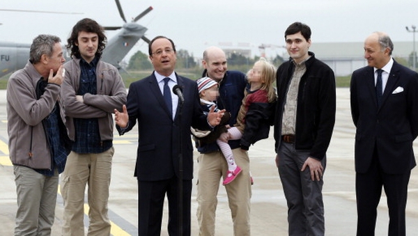 The journalists were greeted by French President Francois Hollande and their families