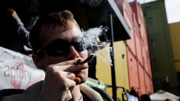 Anthony Nitowski smokes two joints outside at Hempfest in Seattle, Washington