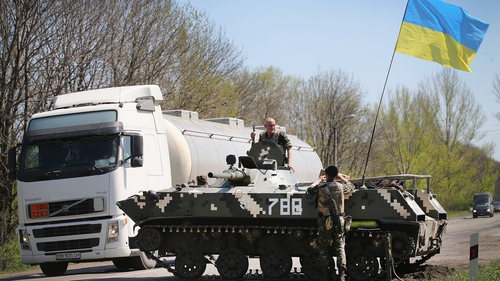 Ukrainian soldiers guard a roadblock along the motorway near Slaviansk