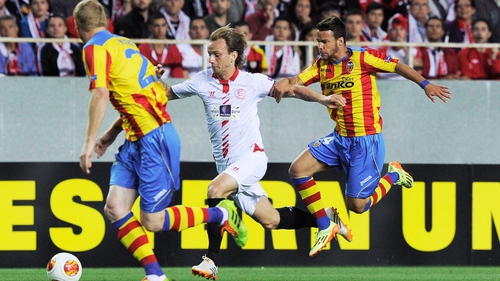 Sevilla midfielder Ivan Rakitic (C) vies with Valencia's Jeremy Mathieu (L) and Juan Bernat