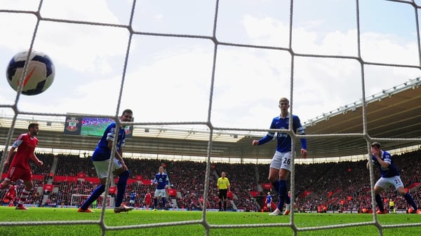 Seamus Coleman (R) holds his head in his hands as puts through his own goal