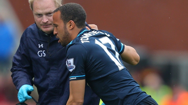 Andros Townsend is helped to the touchline during his side's game against Stoke