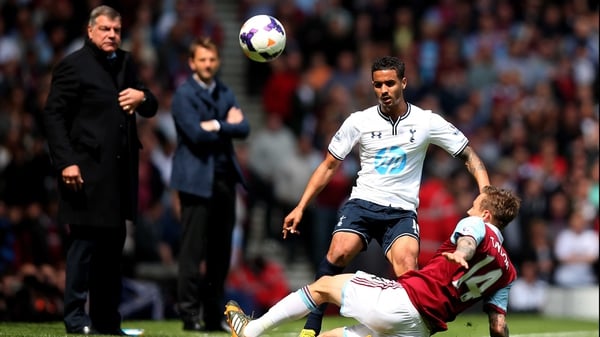 Kyle Naughton of Spurs is challenged by Matthew Taylor