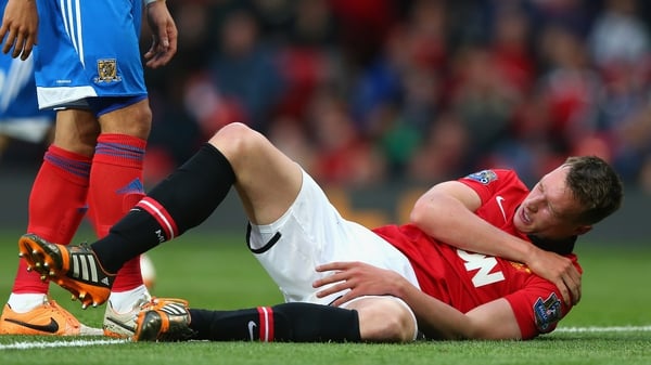 Phil Jones holds his shoulder during the match between Manchester United and Hull City