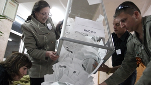 Members of a local election commission empty ballot boxes in Luhansk in eastern Ukraine