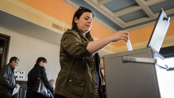 A woman casts her ballot in Bulle, western Switzerland