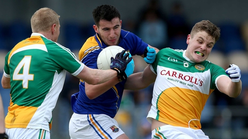 Longford's Mark Hughes battles with Niall Darby and Johnny Moloney of Offaly