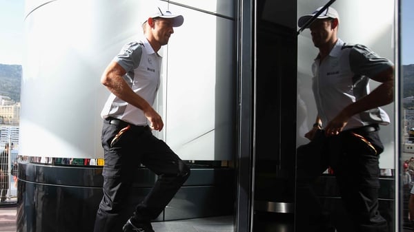 Jenson Button walks across the paddock ahead of the Monaco Grand Prix