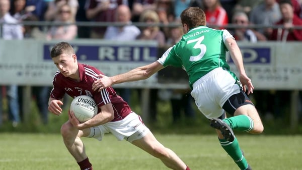 Galway's Paul Varley evades the attention London's Stephen Curran