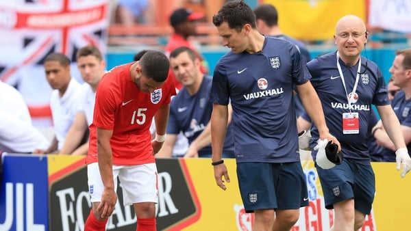Alex Oxlade-Chamberlain walks off the pitch with a knee injury during Wednesday's friendly