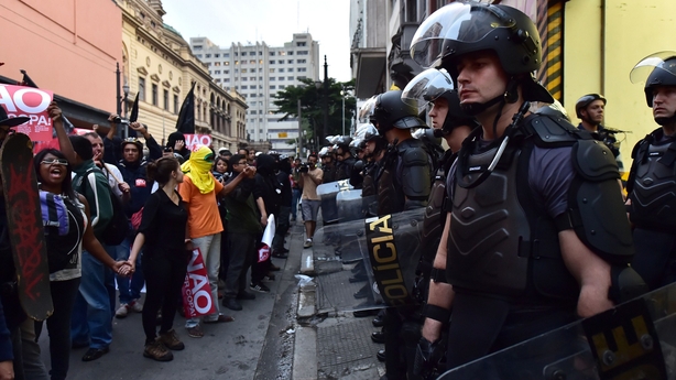 Riot police stand guard during Brazil anti-World Cup protest
