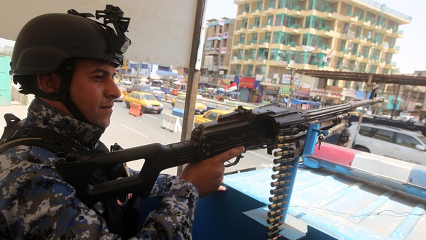 An Iraqi police officer mans a checkpoint in the capital Baghdad