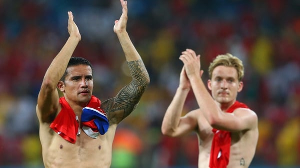 Tim Cahill (L) and Ben Halloran acknowledge the Australia fans after losing to Chile 3-1