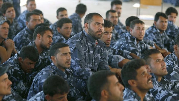 Iraqi volunteers in their new uniforms gather at a centre following a speech by the Iraqi prime minister