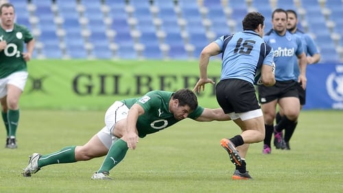 Paddy Butler, who scored two tries, tackles Jeronimo Etcheverry of Uruguay